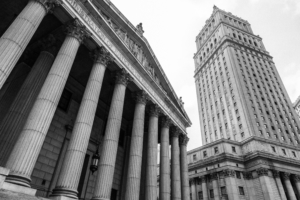 New York, USA - 5 September 2014: Monochrome view looking up at the New York State Supreme Court Building and the US Justice Building, in Lower Manhattan, New York.