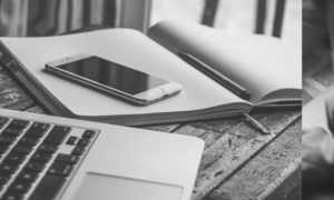 Desk with a computer, cell phone and desk in black and white